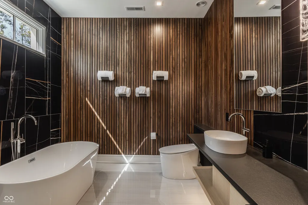 Newly Built $11.9 Million European-Inspired Estate Debuts on 14 Wooded Acres in Carmel, Indiana 9 Spa-inspired primary bathroom with freestanding soaking tub, designer wood accents and contemporary finishes in the $11.9 million Carmel luxury estate