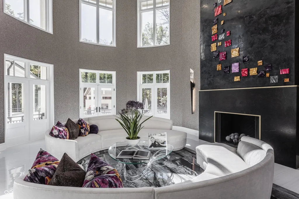 Newly Built $11.9 Million European-Inspired Estate Debuts on 14 Wooded Acres in Carmel, Indiana 3 Two-story living room with contemporary fireplace, designer artwork and floor-to-ceiling windows inside the $11.9 million Carmel luxury estate
