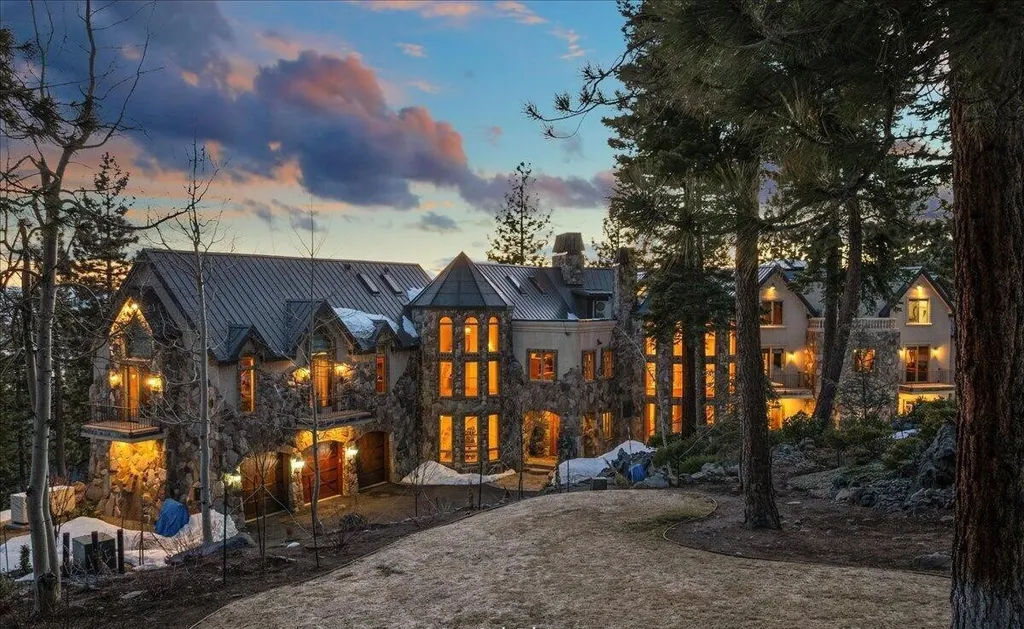 Former Home of a Rock and Roll Hall of Famer Above Lake Tahoe Lists for $43 Million 3 Grand exterior of the $43 million Lake Tahoe estate in Incline Village Nevada featuring stone architecture, illuminated windows and a private forest setting