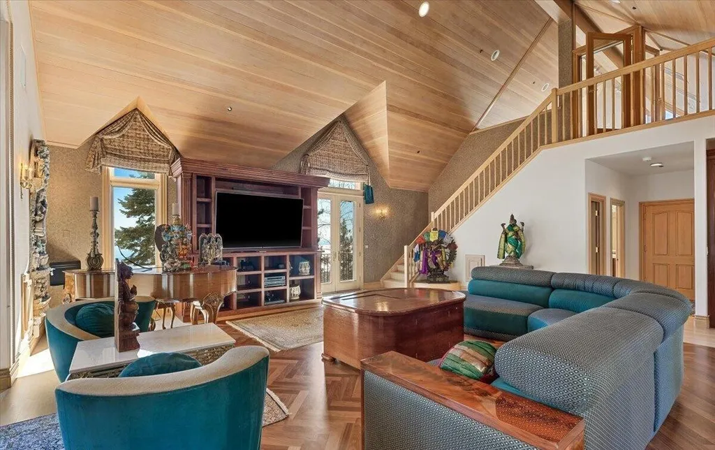 Former Home of a Rock and Roll Hall of Famer Above Lake Tahoe Lists for $43 Million 12 Elegant family lounge with vaulted ceilings, grand piano and lake-view windows inside the Lake Tahoe estate