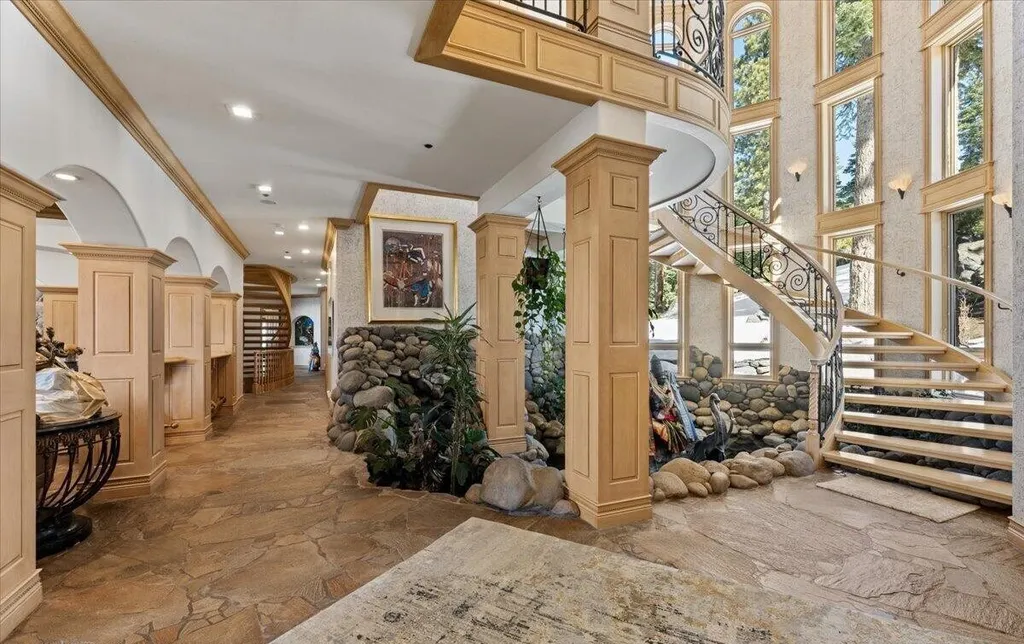 Former Home of a Rock and Roll Hall of Famer Above Lake Tahoe Lists for $43 Million 4 Grand foyer of the Lake Tahoe estate featuring a spiral staircase, indoor koi pond, stone accents and soaring windows overlooking the forest
