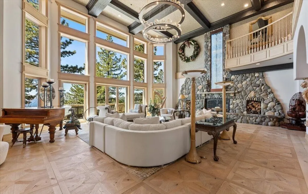 Former Home of a Rock and Roll Hall of Famer Above Lake Tahoe Lists for $43 Million 5 Great room in the Lake Tahoe luxury estate featuring floor-to-ceiling windows, stone fireplace and panoramic lake views