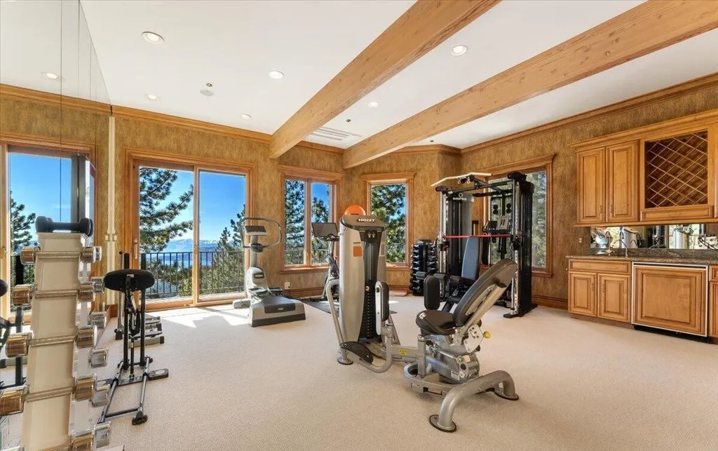 Former Home of a Rock and Roll Hall of Famer Above Lake Tahoe Lists for $43 Million 11 Private fitness center with strength and cardio equipment overlooking Lake Tahoe through floor-to-ceiling windows
