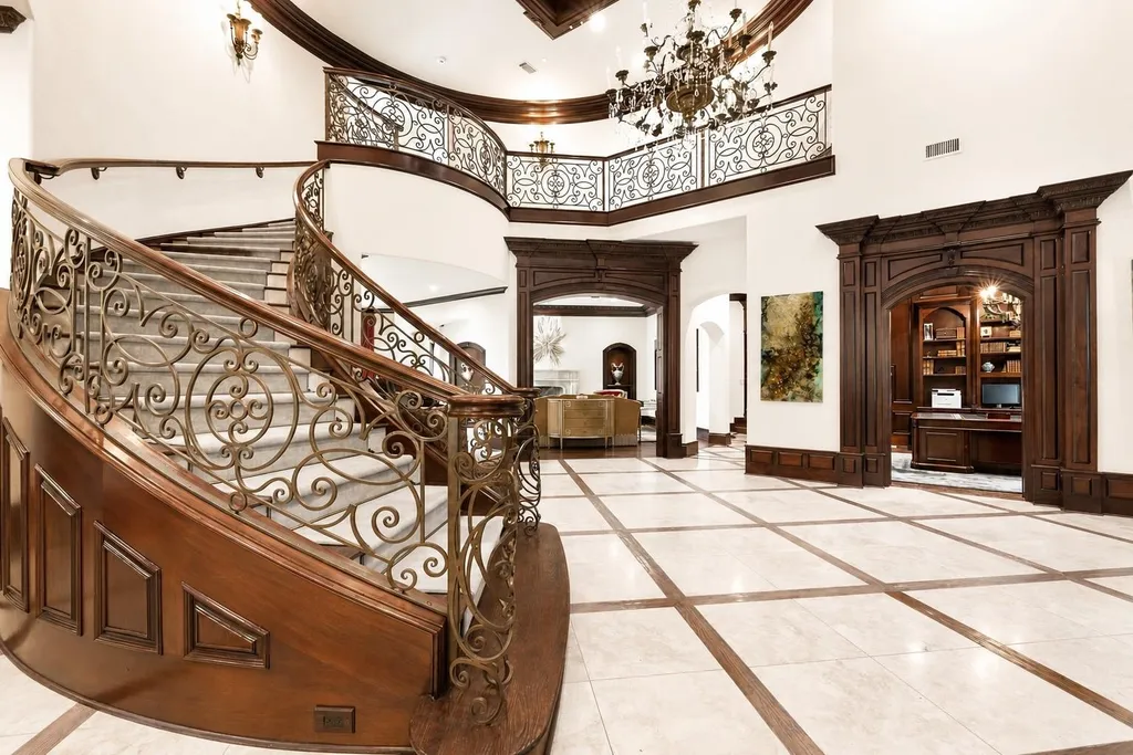 This $11.9 Million Plano Estate Occupies Former Willow Bend Polo Grounds and Spans Nearly Two Acres 4 Grand foyer at the Kings Gate estate in Plano Texas featuring a sweeping curved staircase, custom millwork and double-height ceilings