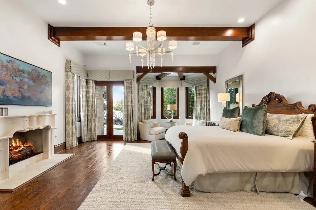 This $11.9 Million Plano Estate Occupies Former Willow Bend Polo Grounds and Spans Nearly Two Acres 9 Luxurious primary bedroom suite at the Kings Gate estate in Plano Texas featuring a fireplace, hardwood floors and private sitting area