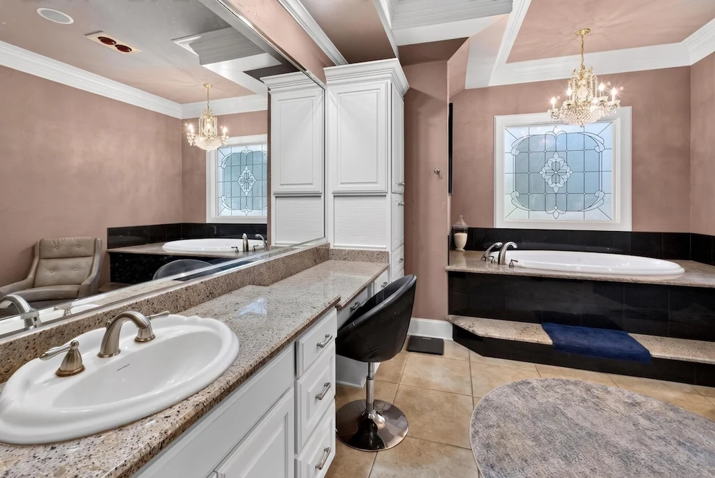 16104 County Road 294 – Primary Bathroom 16104 County Road 294, Arp: white cabinetry, a long vanity and a dark soaking tub define the primary bathroom.