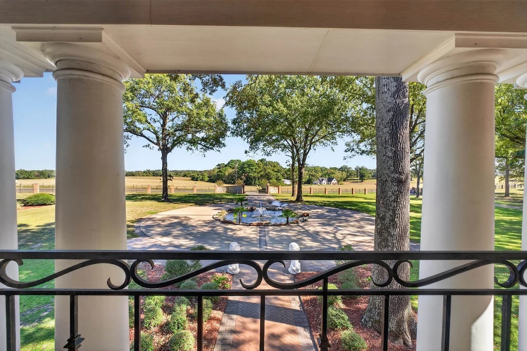 16104 County Road 294 – Front Balcony View 16104 County Road 294, Arp: a front balcony looks across the circular drive and mature trees.