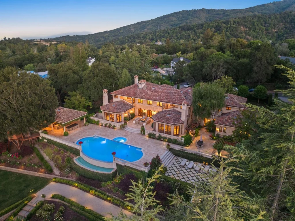 10285 Magdalena Rd – Aerial Poolside Estate 10285 Magdalena Rd, Los Altos Hills: an aerial view frames the illuminated villa, pool and terraced gardens.