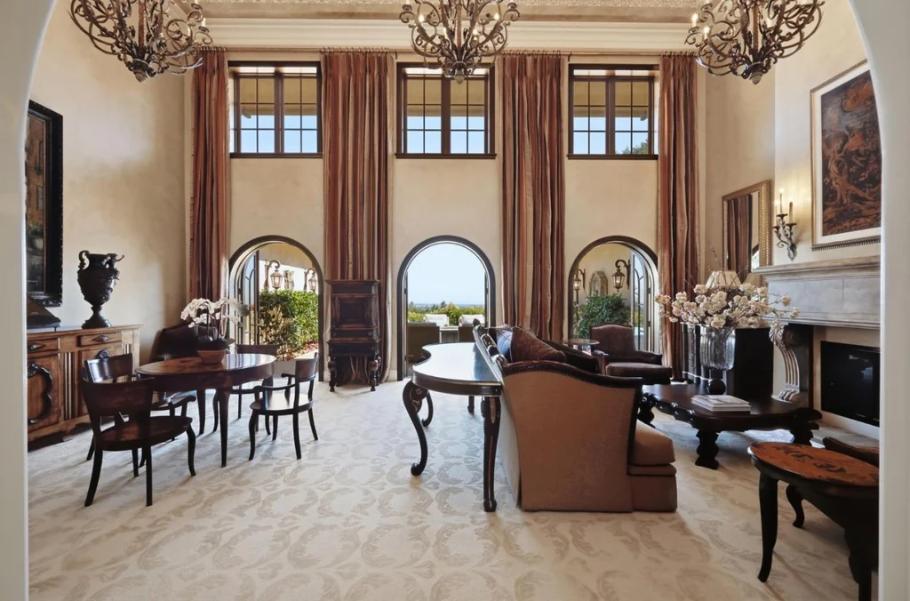 10285 Magdalena Rd – Grand Living Room 10285 Magdalena Rd, Los Altos Hills: tall windows and ornate chandeliers define the grand living room.