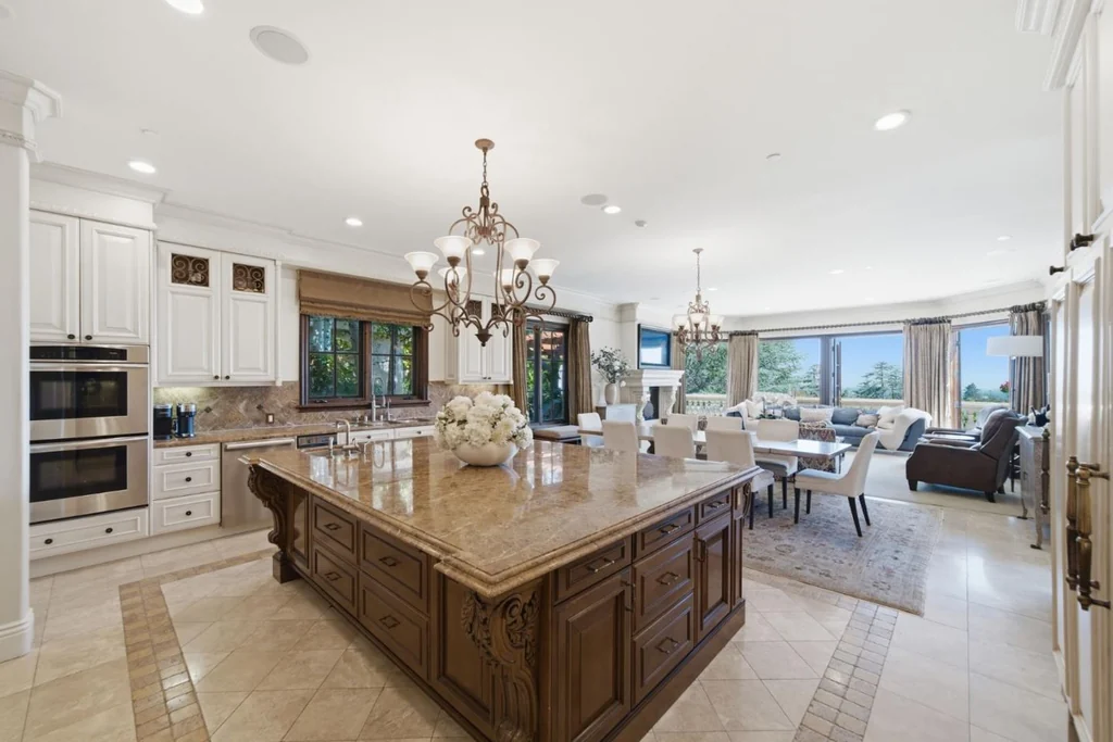 10285 Magdalena Rd – Island Kitchen 10285 Magdalena Rd, Los Altos Hills: a substantial wood island anchors the kitchen beneath a chandelier.