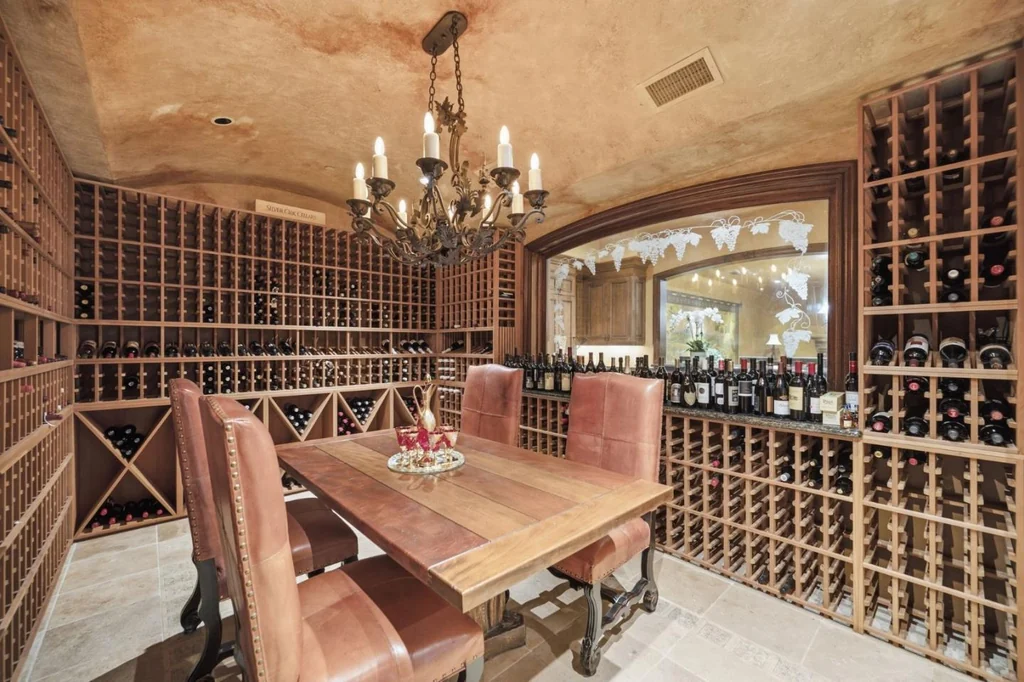 10285 Magdalena Rd – Wine Cellar Dining 10285 Magdalena Rd, Los Altos Hills: wine racks surround a dedicated dining table in the cellar.