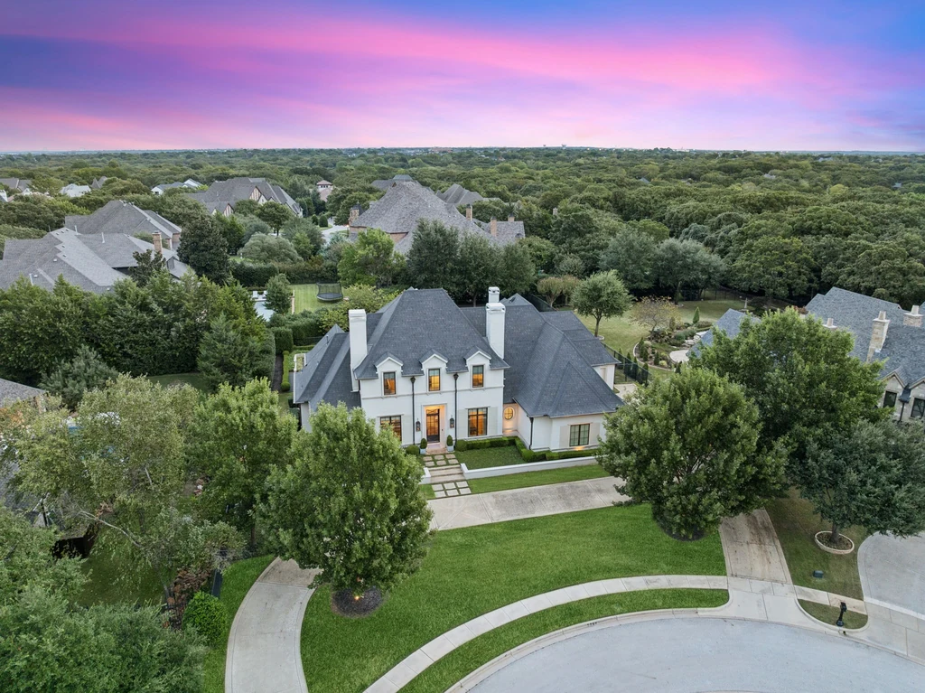 1255 Bolton Ct – Aerial Estate Overview 1255 Bolton Ct, Southlake: an elevated view shows the white brick residence, circular drive and surrounding trees.