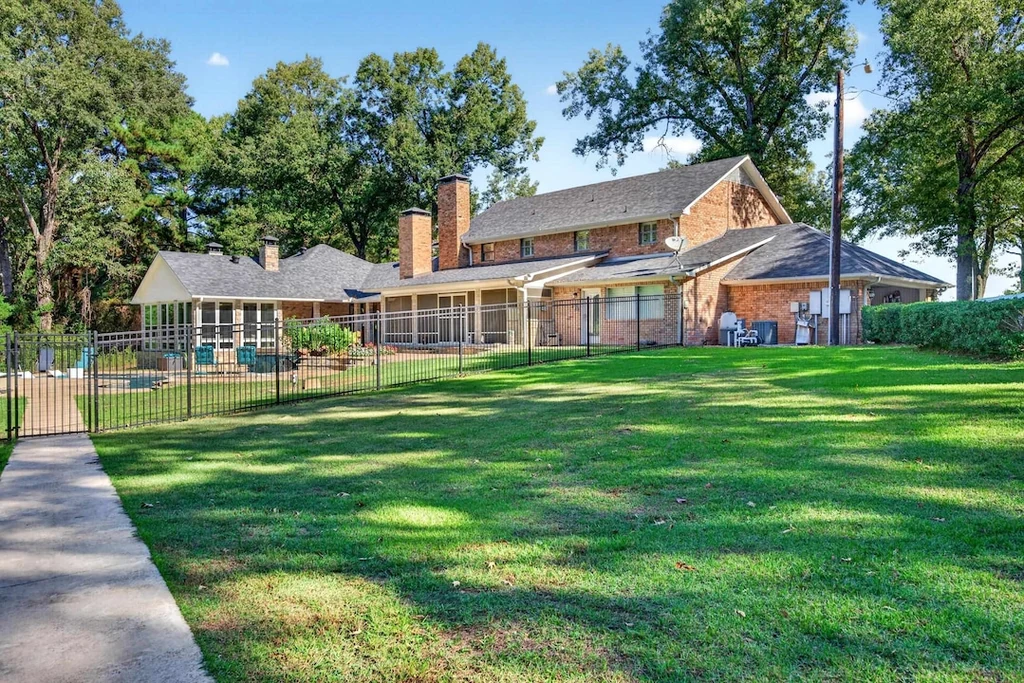 16104 County Road 294 – Rear Garden Lawn 16104 County Road 294, Arp: a broad lawn extends beyond the rear elevation and screened outdoor living space.
