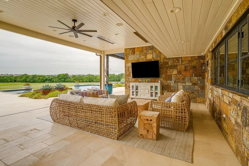 A Texas Estate Built Around Circa-1740 Scottish Timbers Lists for $14,250,000 12 The covered terrace looks across the pool toward open pasture at 13000 Old Weatherford Rd, Aledo