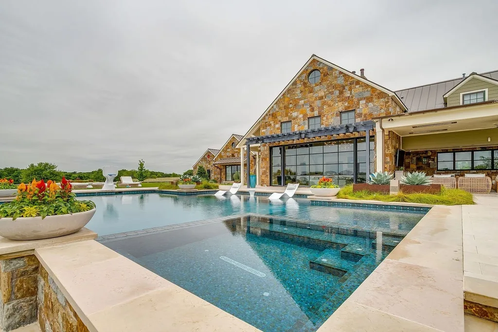 A Texas Estate Built Around Circa-1740 Scottish Timbers Lists for $14,250,000 14 Glass tile, shallow lounging areas and an integrated spa shape the pool terrace at 13000 Old Weatherford Rd, Aledo