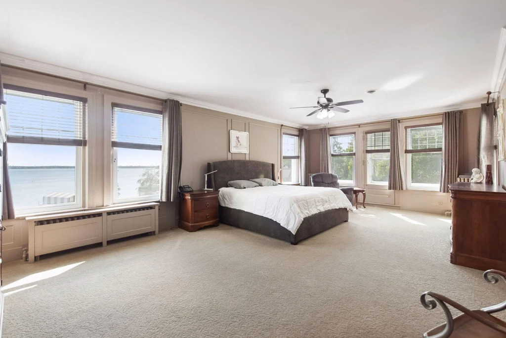 1305 Shoreline Dr — Bedroom Lake Views A spacious bedroom overlooks Lake Minnetonka through multiple windows at 1305 Shoreline Dr.