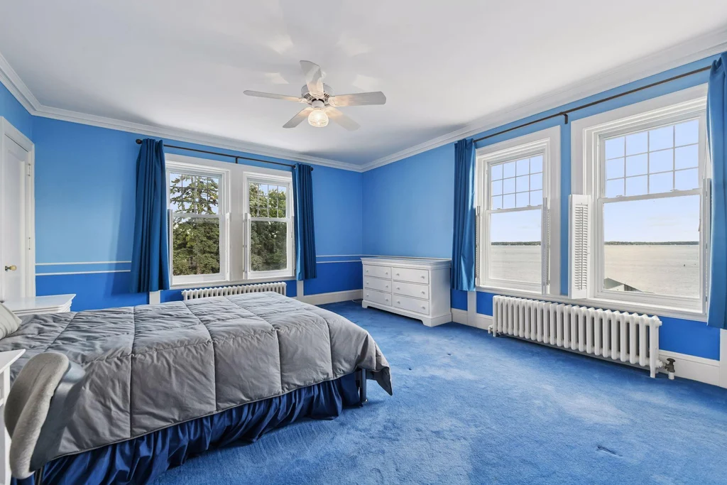 1305 Shoreline Dr — Blue Bedroom A blue bedroom illustrates the individual character of the sleeping quarters at 1305 Shoreline Dr.