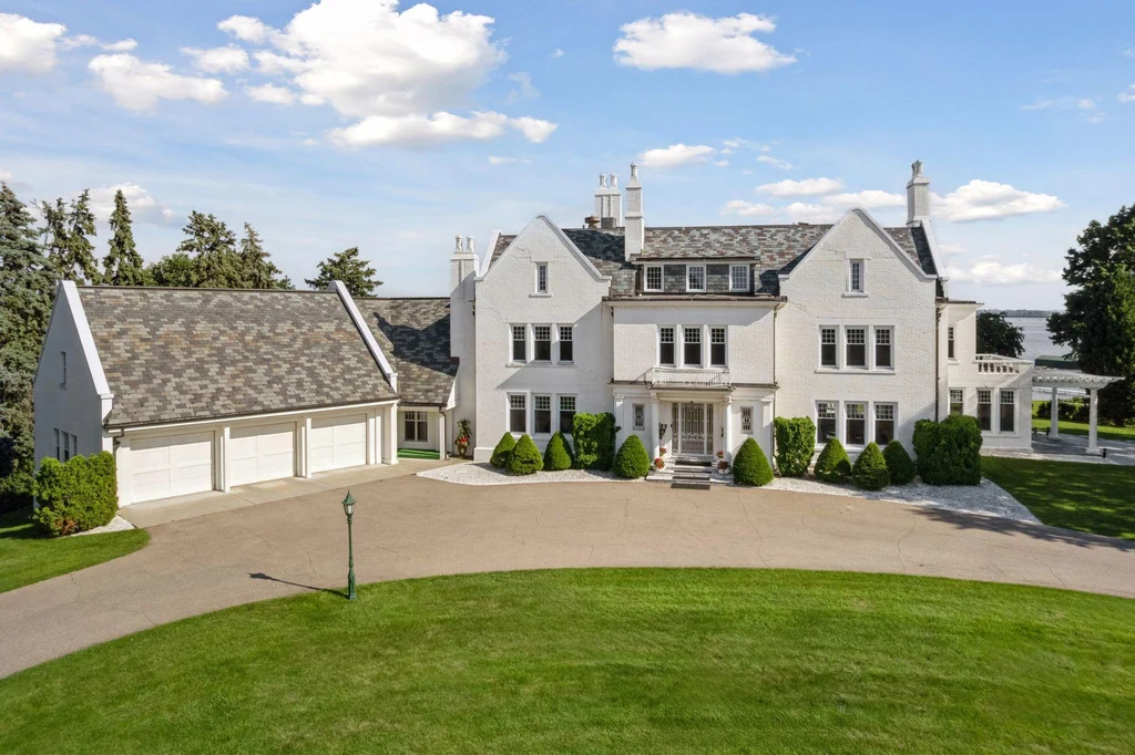 1305 Shoreline Dr — Georgian Revival Front Exterior White masonry, a columned entrance and a slate roof define the front elevation at 1305 Shoreline Dr.