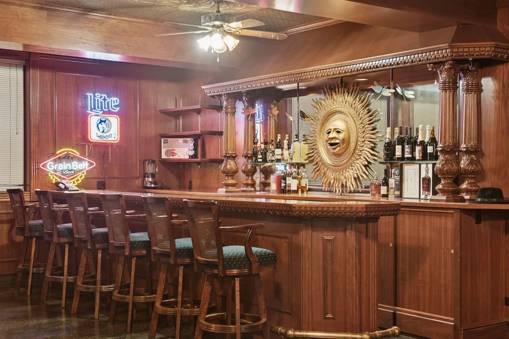 1305 Shoreline Dr — Lower Level Wet Bar A long wood bar provides a dedicated gathering space downstairs at 1305 Shoreline Dr.