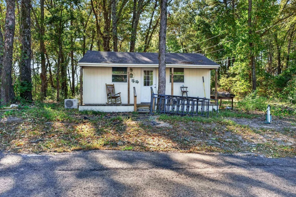 16104 County Road 294 – Detached Craft Building 16104 County Road 294, Arp: a small detached building sits in a wooded setting beside the drive.