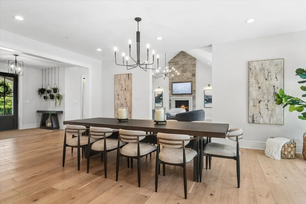 Inverness Estate With a Speakeasy-Style Lounge and Indoor Golf Simulator Lists for $2,750,000 6 Long dining table beside the kitchen and great room in Inverness, Illinois