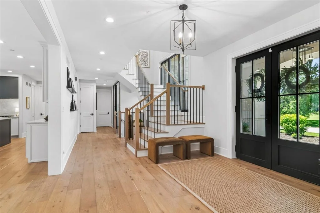 Inverness Estate With a Speakeasy-Style Lounge and Indoor Golf Simulator Lists for $2,750,000 2 Glass front doors and oak staircase in the foyer at 14 Carnoustie Lane in Inverness, Illinois