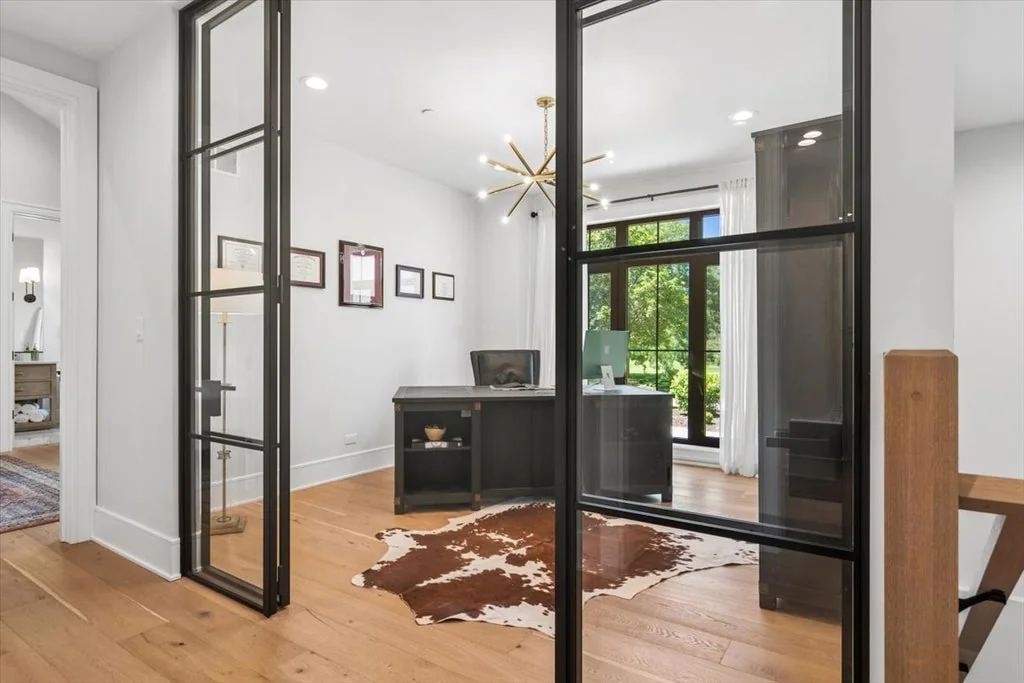Inverness Estate With a Speakeasy-Style Lounge and Indoor Golf Simulator Lists for $2,750,000 8 Home office behind black-framed glass double doors in Inverness, Illinois