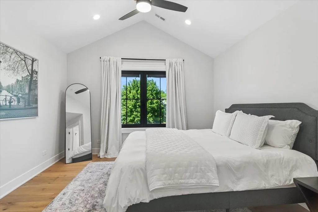 Inverness Estate With a Speakeasy-Style Lounge and Indoor Golf Simulator Lists for $2,750,000 13 Guest bedroom with pale walls and black-framed windows in Inverness, Illinois