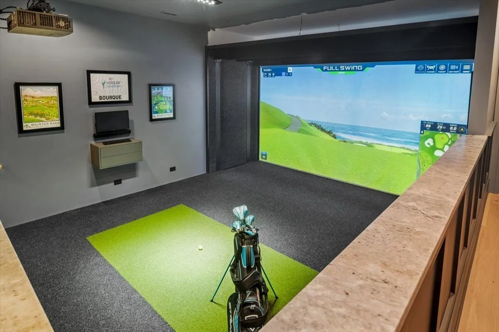 Inverness Estate With a Speakeasy-Style Lounge and Indoor Golf Simulator Lists for $2,750,000 10 Indoor golf simulator with hitting turf and a large projection screen in Inverness, Illinois