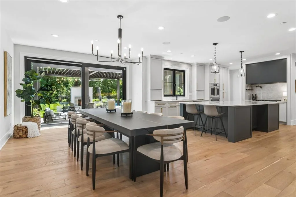 Inverness Estate With a Speakeasy-Style Lounge and Indoor Golf Simulator Lists for $2,750,000 4 Open kitchen with a dark island and white cabinetry at 14 Carnoustie Lane in Inverness, Illinois
