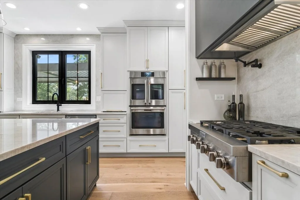 Inverness Estate With a Speakeasy-Style Lounge and Indoor Golf Simulator Lists for $2,750,000 5 Kitchen range, pot filler and double wall ovens beside a dark island in Inverness, Illinois
