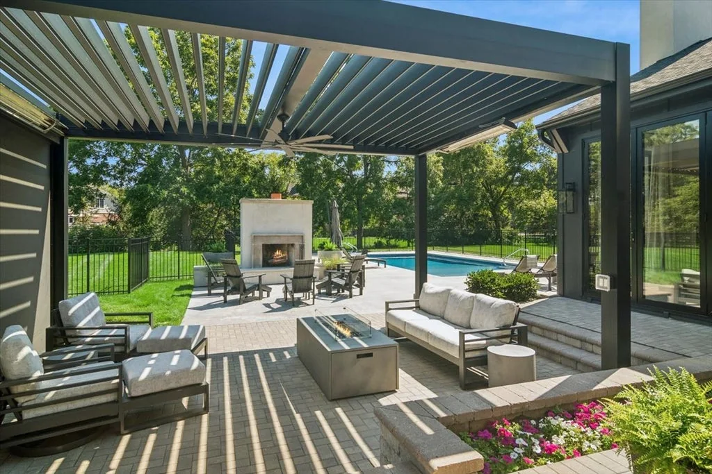 Inverness Estate With a Speakeasy-Style Lounge and Indoor Golf Simulator Lists for $2,750,000 17 Outdoor seating and fire table beneath a louvered pergola in Inverness, Illinois