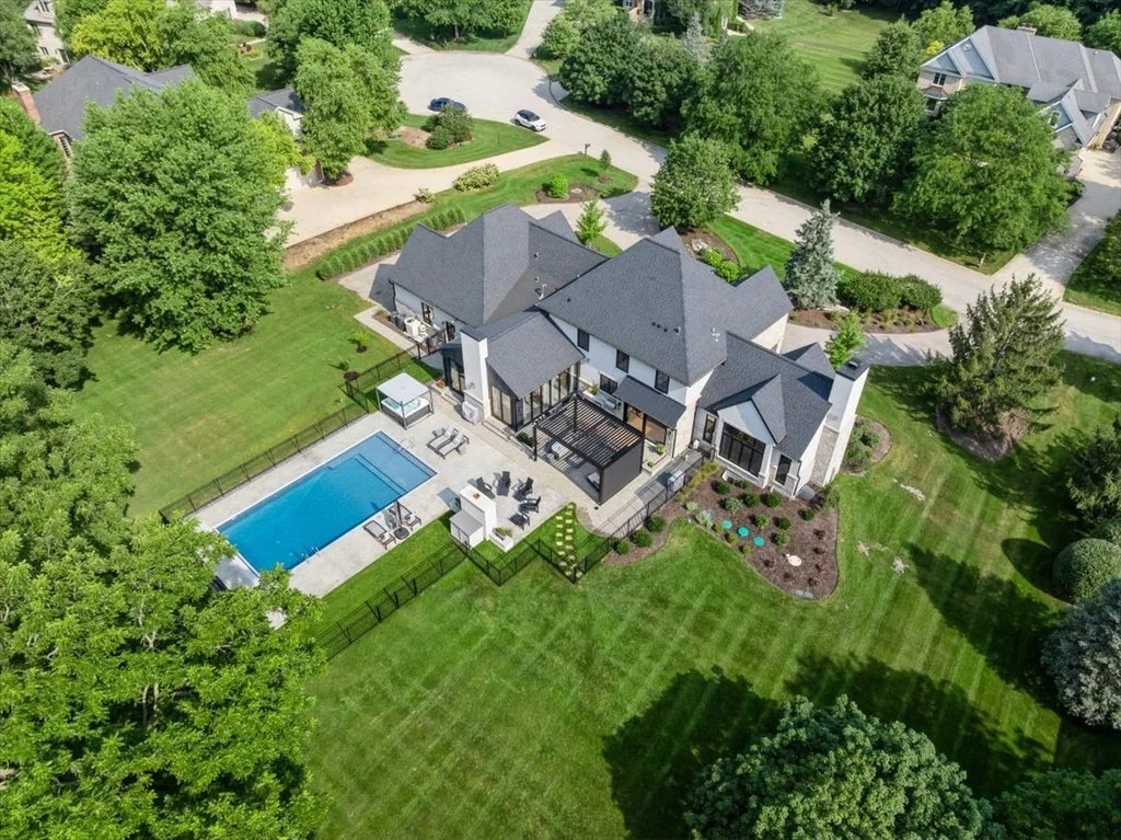 Inverness Estate With a Speakeasy-Style Lounge and Indoor Golf Simulator Lists for $2,750,000 20 High aerial view of the house, pool and landscaped lot in Inverness, Illinois