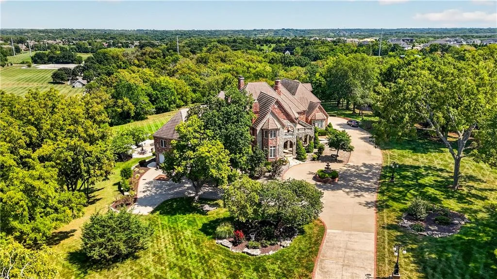 Leawood Estate Bordered by Ironwoods Park on Two Sides Asks $6,500,000 5 An elevated front view shows the residence within its landscaped grounds at 14707 Mission Rd, Leawood