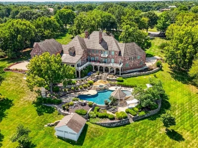 Leawood Estate Bordered by Ironwoods Park on Two Sides Asks $6,500,000 1 An elevated rear view brings the house, terraced pool garden and mature trees into one frame at 14707 Mission Rd, Leawood