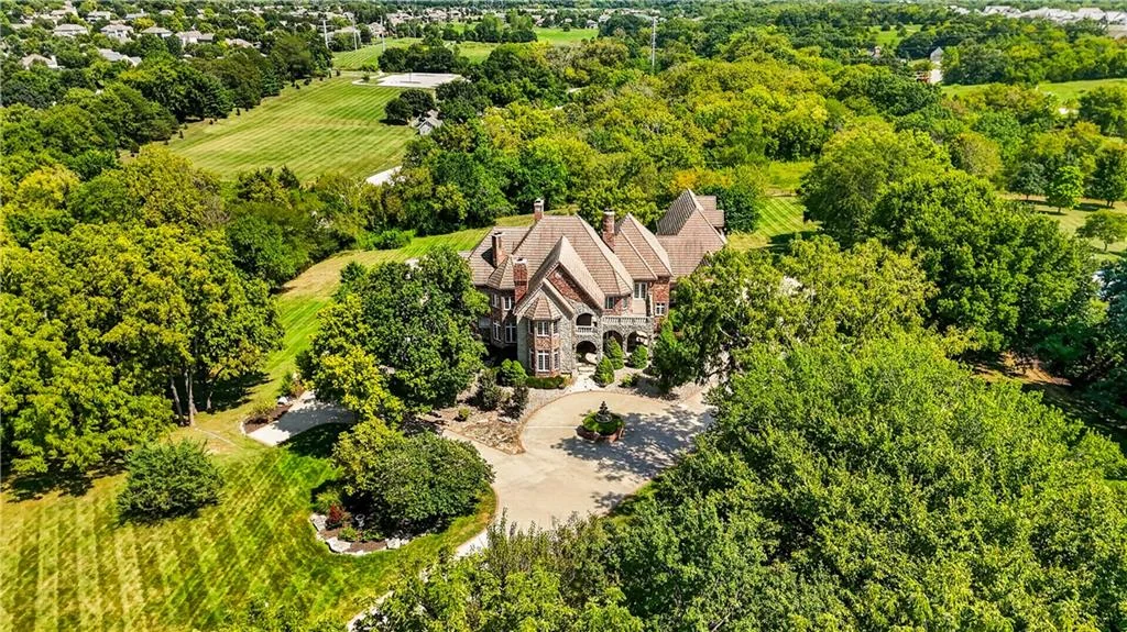 Leawood Estate Bordered by Ironwoods Park on Two Sides Asks $6,500,000 4 Mature tree cover surrounds the house and its approach at 14707 Mission Rd, Leawood