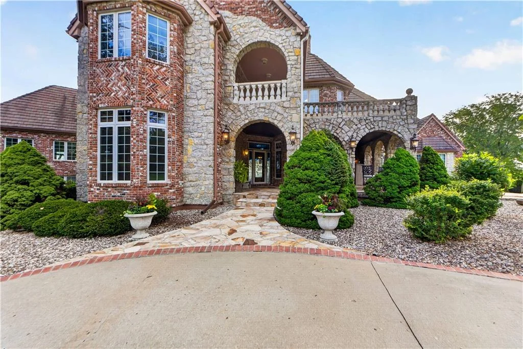 Leawood Estate Bordered by Ironwoods Park on Two Sides Asks $6,500,000 3 Stone columns and a sequence of arches define the main entrance at 14707 Mission Rd, Leawood