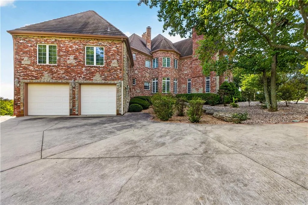 Leawood Estate Bordered by Ironwoods Park on Two Sides Asks $6,500,000 15 The attached garage forms part of the brick-clad residence at 14707 Mission Rd, Leawood