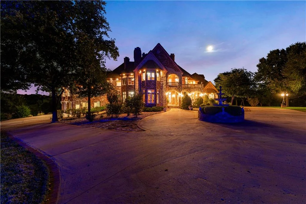 Leawood Estate Bordered by Ironwoods Park on Two Sides Asks $6,500,000 18 Evening illumination picks out the arched entrance and brick facade at 14707 Mission Rd, Leawood