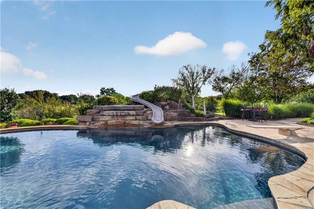 Leawood Estate Bordered by Ironwoods Park on Two Sides Asks $6,500,000 9 Rockwork and a curving slide give the pool garden a distinct focal point at 14707 Mission Rd, Leawood