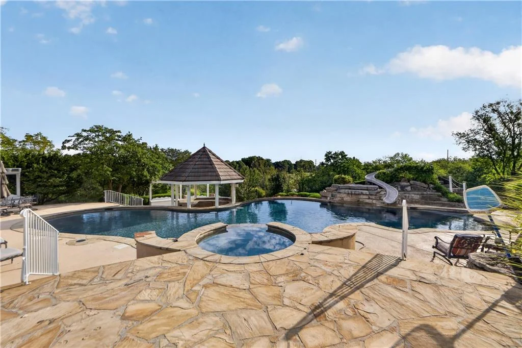 Leawood Estate Bordered by Ironwoods Park on Two Sides Asks $6,500,000 8 A raised circular spa sits beside the free-form pool at 14707 Mission Rd, Leawood