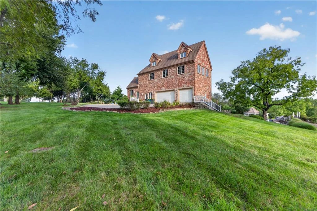 Leawood Estate Bordered by Ironwoods Park on Two Sides Asks $6,500,000 16 An open side lawn contrasts with the mature planting around the house at 14707 Mission Rd, Leawood