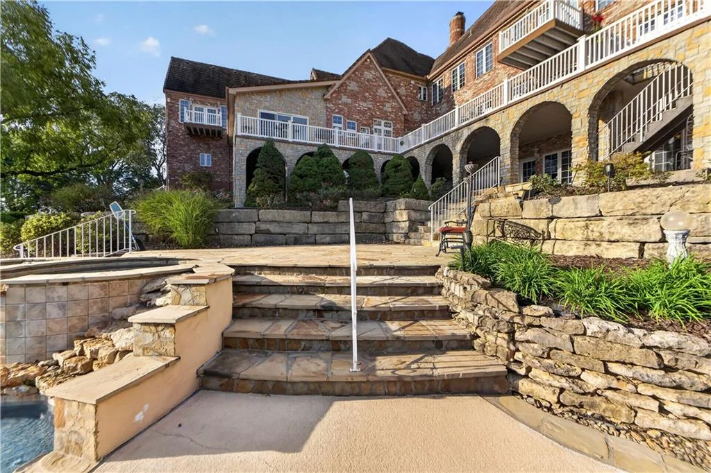 Leawood Estate Bordered by Ironwoods Park on Two Sides Asks $6,500,000 6 Stone steps link the house to the lower pool terrace at 14707 Mission Rd, Leawood