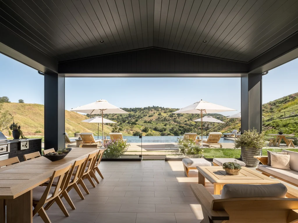 25211 Jim Bridger Rd – Covered Outdoor Terrace 25211 Jim Bridger Rd, Hidden Hills: a sheltered terrace provides dining and lounge areas facing the hills.