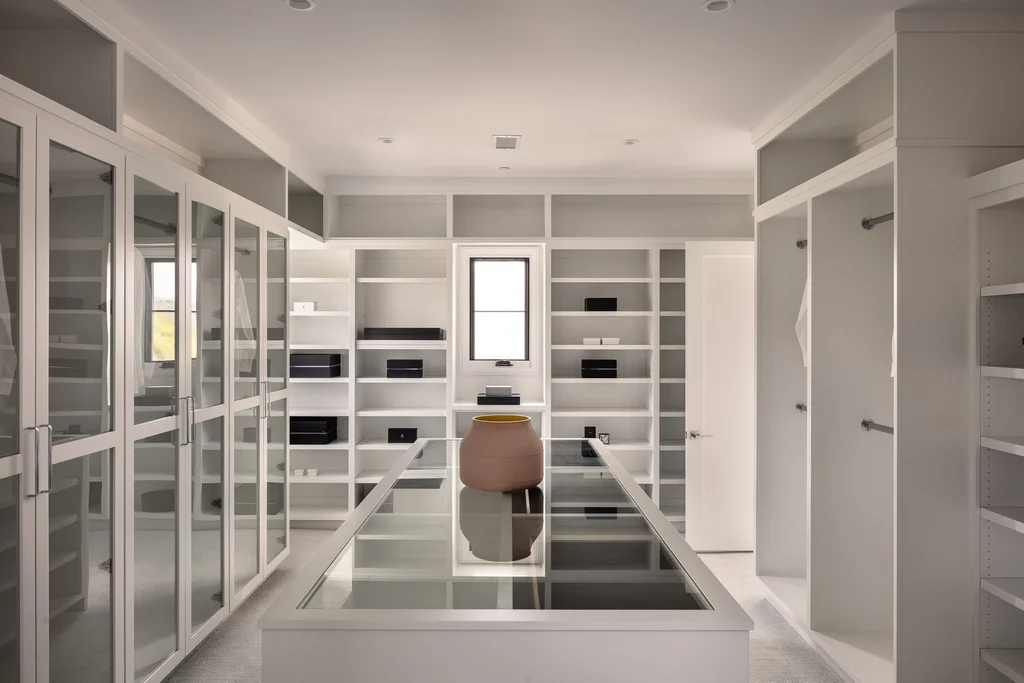 25211 Jim Bridger Rd – Dressing Room 25211 Jim Bridger Rd, Hidden Hills: glass-front cabinetry lines the expansive dressing room.