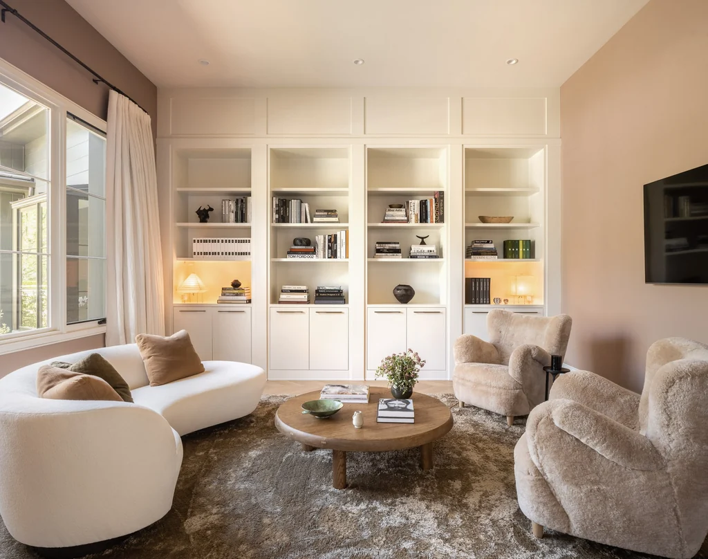 25211 Jim Bridger Rd – Library Lounge 25211 Jim Bridger Rd, Hidden Hills: built-in shelving frames a softly furnished lounge.