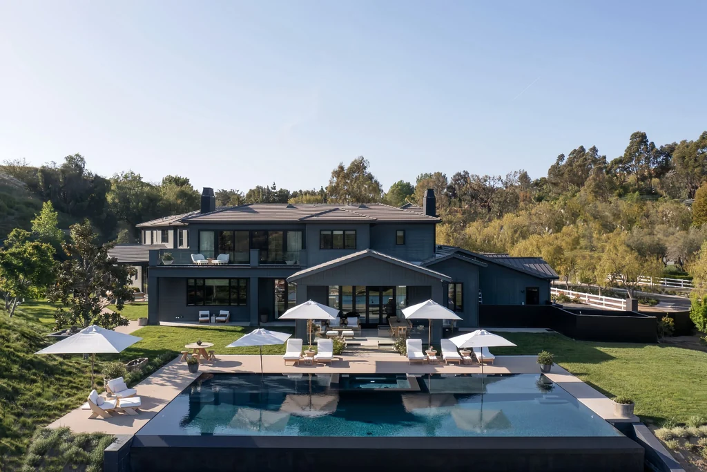 25211 Jim Bridger Rd – Poolside Estate Overview 25211 Jim Bridger Rd, Hidden Hills: the charcoal exterior overlooks the pool and landscaped grounds.