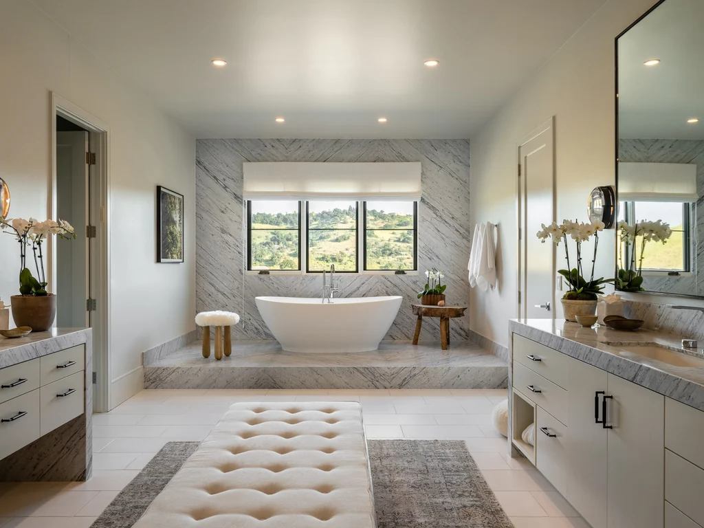 25211 Jim Bridger Rd – Primary Bathroom 25211 Jim Bridger Rd, Hidden Hills: a freestanding bathtub sits beneath a wide window in the primary bathroom.