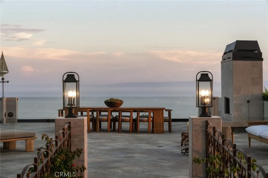 3201 Campanil Dr – Outdoor Fireplace Terrace 3201 Campanil Dr, Santa Barbara: an outdoor fireplace and dining area overlook the coast at sunset.