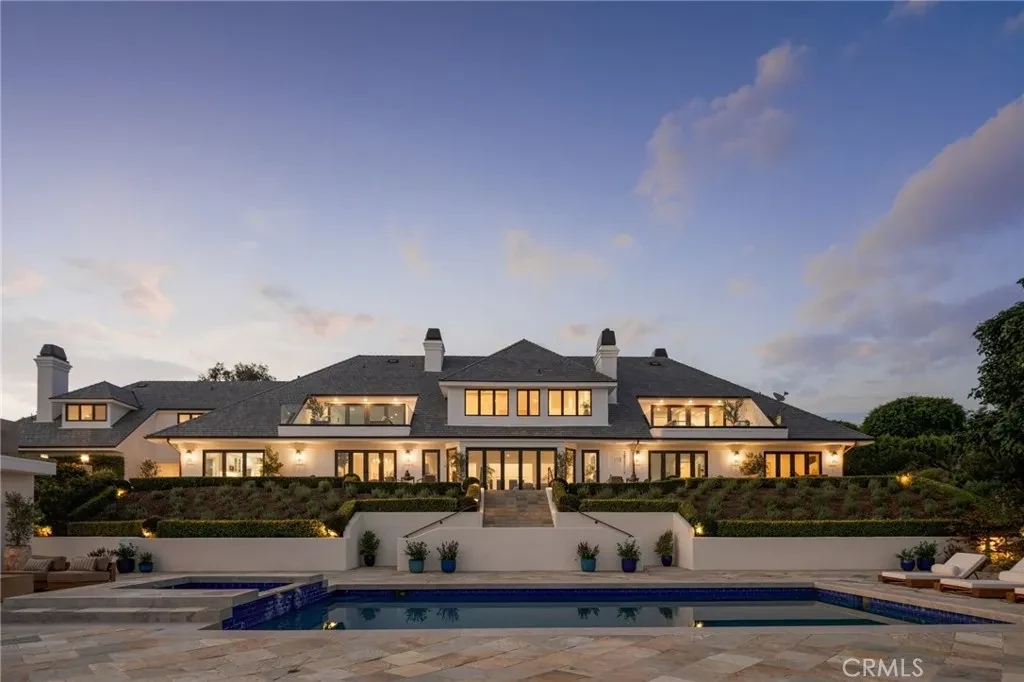 3201 Campanil Dr – Poolside Estate Dusk 3201 Campanil Dr, Santa Barbara: the illuminated residence overlooks the pool terrace at dusk.